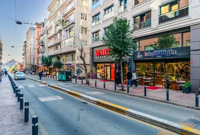 a city street with buildings and a car on the road at Roys Hotel & Suites in Istanbul