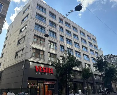 a tall white building with a sign on it at Roys Hotel & Suites in Istanbul