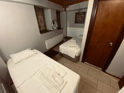 a small room with two beds and a mirror at Hotel No 34 in Istanbul