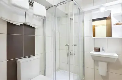 a bathroom with a shower and a toilet and a sink at Hotel No 34 in Istanbul
