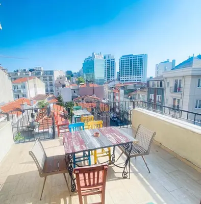 a table and chairs on a balcony with a view of a city at Hotel No 34 in Istanbul
