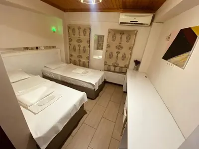 a small room with two beds and a table at Hotel No 34 in Istanbul