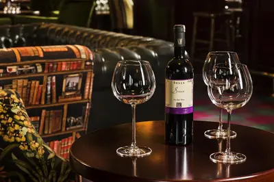 a bottle of wine and two wine glasses on a table at Ramada by Wyndham Istanbul Florya in Istanbul