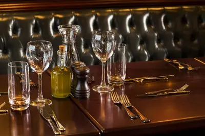 a table with wine glasses and a bottle on it at Ramada by Wyndham Istanbul Florya in Istanbul