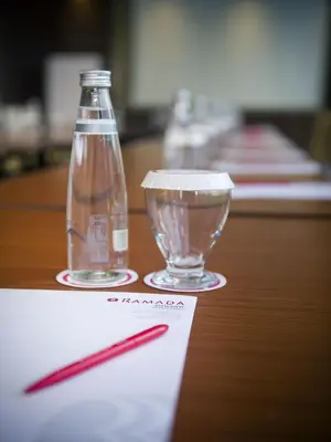 a bottle of water and a glass on a table at Ramada by Wyndham Istanbul Florya in Istanbul