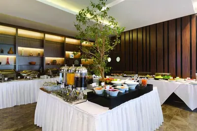 a restaurant with white tables with food on them at Ramada by Wyndham Istanbul Florya in Istanbul