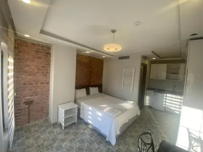a bedroom with a bed and a brick wall at The Red Tent Loft Suites in Istanbul