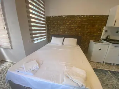 a bedroom with a large white bed with two pillows at The Red Tent Loft Suites in Istanbul