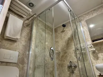 a shower stall with a glass door in a bathroom at Hotel Visa in Istanbul