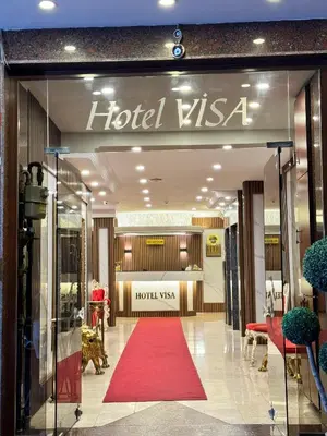 a store front with a red carpet in front of a store at Hotel Visa in Istanbul