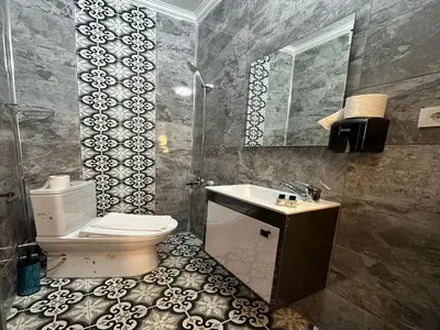 a bathroom with a toilet and a sink and a mirror at Asıl Kosova Hotel in Istanbul