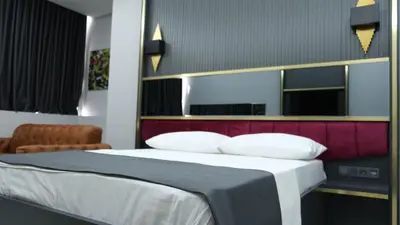 a bedroom with a large bed with a red headboard at 216 Prestige Hotel in Istanbul