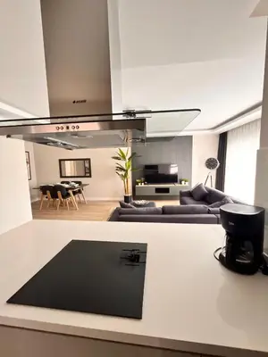 a kitchen and living room with couches and a table at Sense Suite Residence-KAPALI in Istanbul
