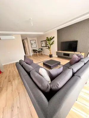 a living room with a large gray couch at Sense Suite Residence-KAPALI in Istanbul