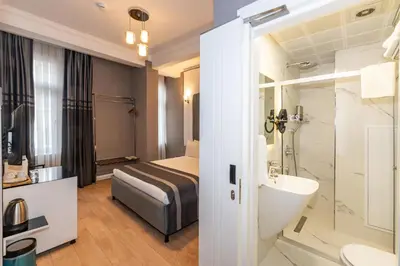 a hotel bathroom with a bed and a sink at The Now Hotel in Istanbul