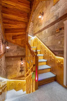 a staircase in a room with wooden walls and wooden ceilings at The Astra Hotel in Istanbul