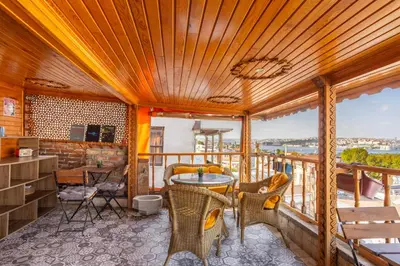 a room with a balcony with a table and chairs at The Astra Hotel in Istanbul