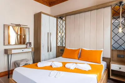 a bedroom with a bed with orange and white pillows at The Astra Hotel in Istanbul