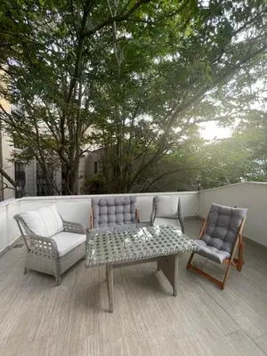 a patio with a couch and two chairs and a table at BOHO HOUSE Istanbul in Istanbul