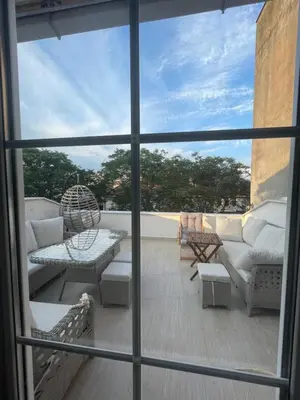 a view of a balcony with a couch and chairs at BOHO HOUSE Istanbul in Istanbul