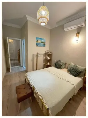 a bedroom with a large bed and a chandelier at BOHO HOUSE Istanbul in Istanbul