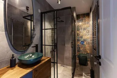 a bathroom with a sink and a glass shower at Panoramic Sea View Loft with Terrace BBQ in Istanbul