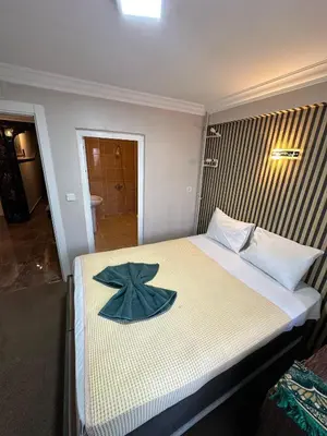 a bedroom with a bed with a star on it at Hotel Metropol 1 in Istanbul