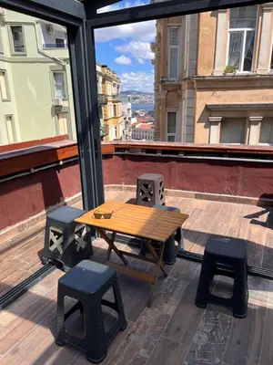 a table and two stools on top of a building at Galata studio in Istanbul