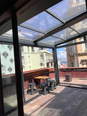a glass roof with a picnic table and benches on a building at Galata studio in Istanbul