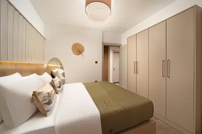 a bedroom with a large white bed and cabinets at Marmada Suites in Istanbul