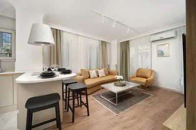 a kitchen and living room with a couch and a table at Marmada Suites in Istanbul