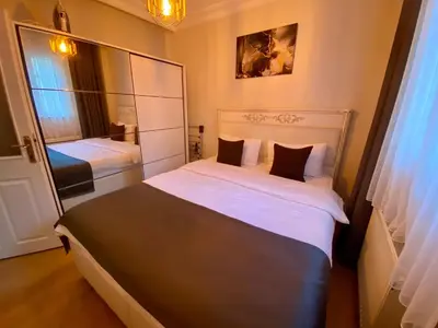 a small bedroom with two beds and a mirror at Sultanahmet Apartment in Istanbul
