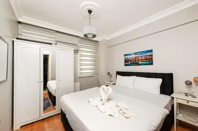 a bedroom with a white bed and a bathroom at Qbra House in Istanbul