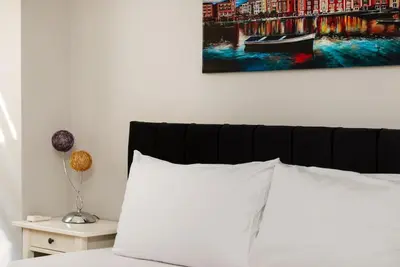 a bed with a white pillow and a painting on the wall at Qbra House in Istanbul