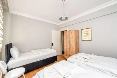 two beds in a room with white walls at Qbra House in Istanbul