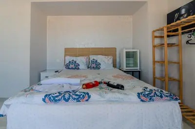 a bedroom with a large bed with a red object on it at İstanbul Airport Black Sea Hotel in Arnavutköy