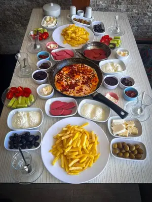 a table topped with plates of food and french fries at İstanbul Airport Black Sea Hotel in Arnavutköy