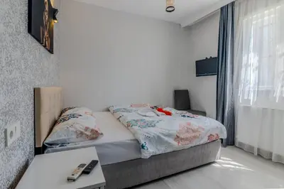 a bedroom with a bed and a table and a window at İstanbul Airport Black Sea Hotel in Arnavutköy