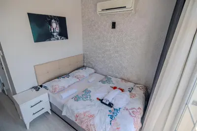 a small bedroom with a bed with a headboard at İstanbul Airport Black Sea Hotel in Arnavutköy