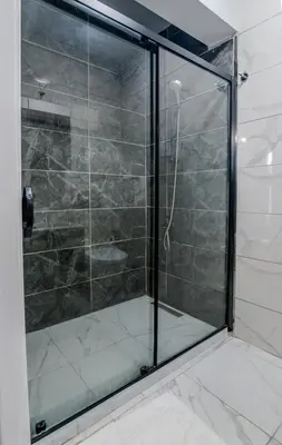a shower with a glass door in a bathroom at İstanbul Airport Black Sea Hotel in Arnavutköy