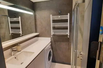 a bathroom with a sink and a shower and a mirror at NEW Modern Central 2BR 2BA in Istanbul