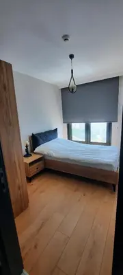 a bedroom with a bed and a large window at NEW Modern Central 2BR 2BA in Istanbul