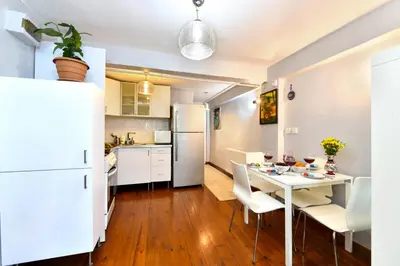 a kitchen and dining room with a white table and chairs at The Maiden Tower From Your Bedroom Romantic View, In Taksim Square in Istanbul