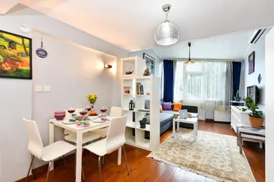 a dining room and living room with a table and chairs at The Maiden Tower From Your Bedroom Romantic View, In Taksim Square in Istanbul