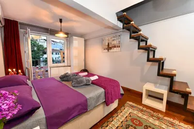 a bedroom with a bed with purple sheets at The Maiden Tower From Your Bedroom Romantic View, In Taksim Square in Istanbul