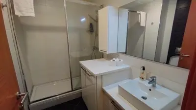 a white bathroom with a sink and a shower at Luxury Residence in Taksim in Istanbul