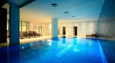 a large swimming pool with blue lights in a building at Luxury Residence in Taksim in Istanbul