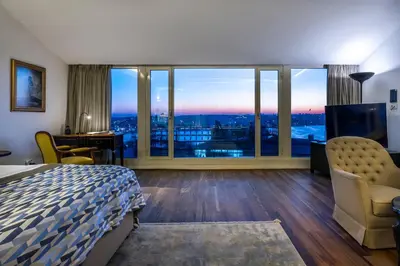 a hotel room with a bed and a large window at Ansen Hotel and Suites in Istanbul