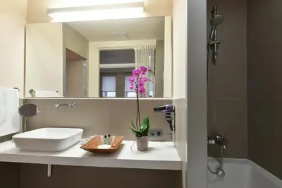a bathroom with a sink and a mirror at Ansen Hotel and Suites in Istanbul