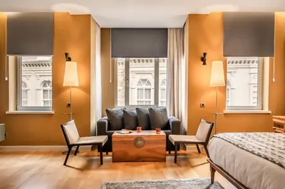 a bedroom with a couch and two chairs and a bed at Ansen Hotel and Suites in Istanbul